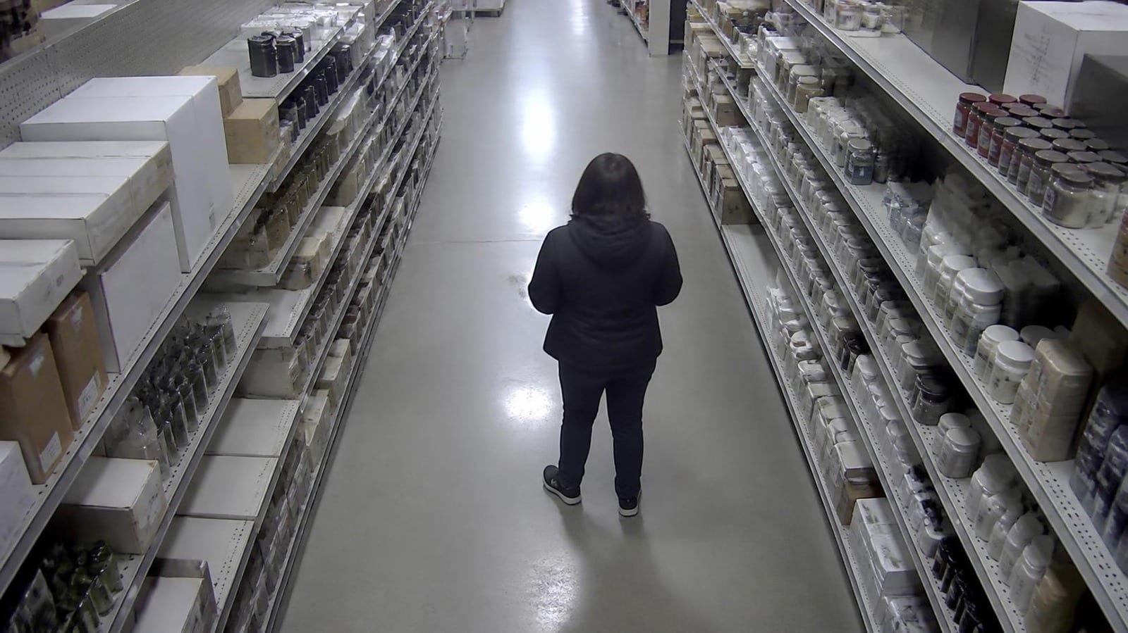 Still frame from a security camera in a shop aisle